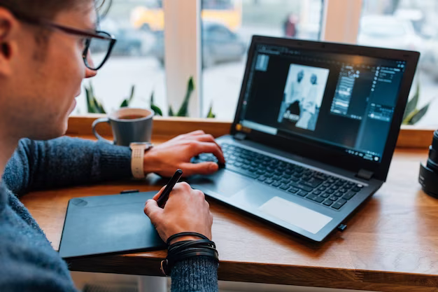 Man working with photos on laptop